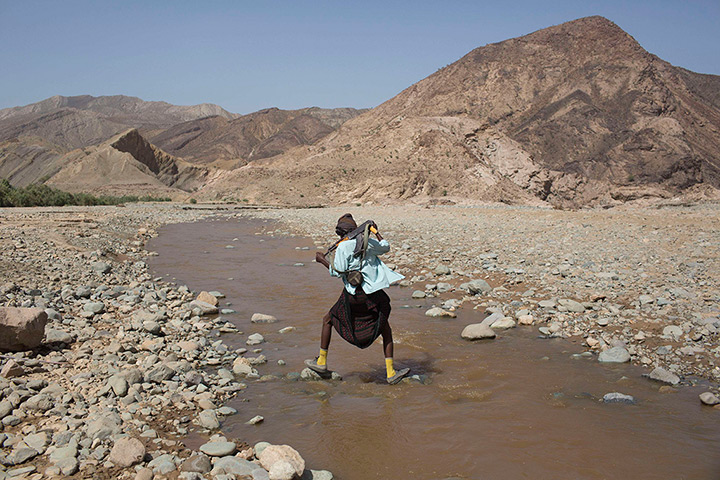 FTA: Siegfried Modola : An armed Afar man crosses a river near the Danakil Depression