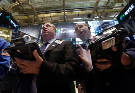 Traders Dan Ryan, left, and Gordon Charlop work on the floor of the New York Stock Exchange Tuesday, May 28, 2013