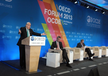 OECD Secretary General Angel Gurria (left) talks as Norway Prime Minister Jens Stoltenberg (C) and OECD Chief Economist Pier Carlo Padoan listen during the presentation of the Economic Outlook during the OECD Week at the OECD headquarters in Paris on May 29, 2013.
