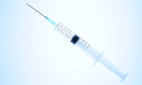 Syringe on blue background