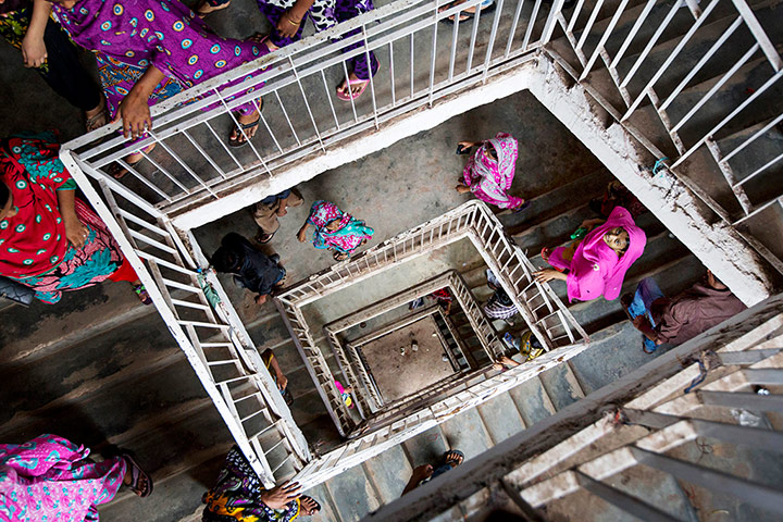 20 Photos: Workers leave a building that houses garment factories in Dhaka