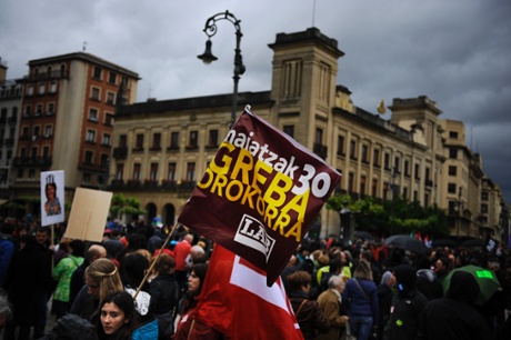 A demonstrator holds a flag reading in Basque language, 'General Strike, May 30', during the general strike in Pamplona, northern Spain on Thursday, May 30, 2013.