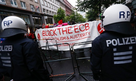 Police stand guard during an anti-capitalist