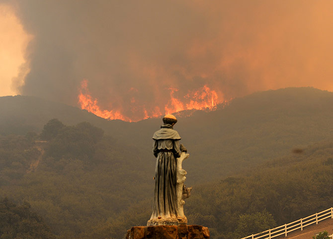 California wildfire: Flames approach a statue of St Francis