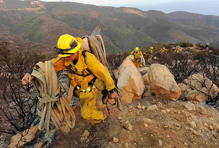 California wildfire: Firefighters make their way out of a canyon