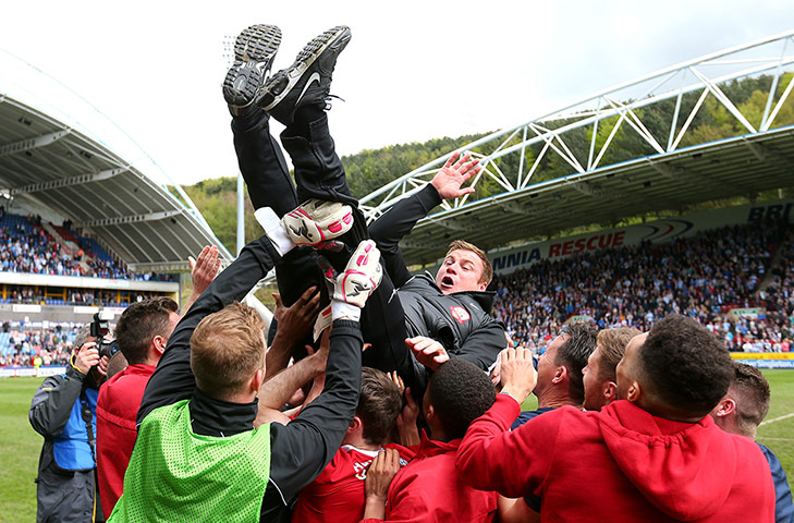 emotions: Barnsley manager David Flitcroft is thrown into the air by his players 