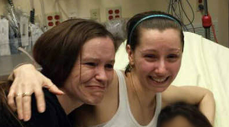 Ohio missing women: Amanda Berry (C) reunited with her sister (L) on 6 May in Cleveland