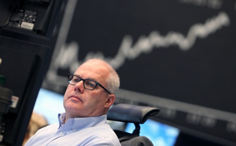 A broker is seen in front of the German Stock Market Index DAX at the stock exchange in Frankfurt, Germany, on May 7, 2013.