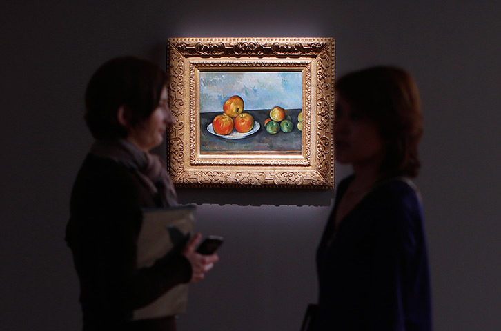 Sotheby's impressionism: Visitors talk near Paul Cezanne's Les Pommes