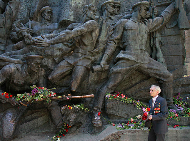 Victory day celebrations: A Ukrainian World War Two veteran passes by a war memorial in Kiev