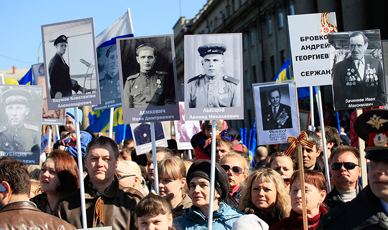 Victory day celebrations: People carry portraits of deceased relatives who were veterans