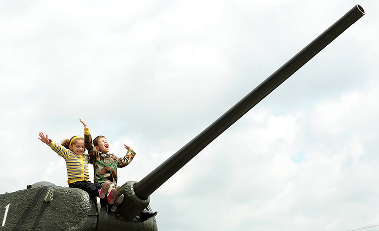 Victory day celebrations: Children sit atop the World War II-era Soviet T-34 tank during Victory Day 