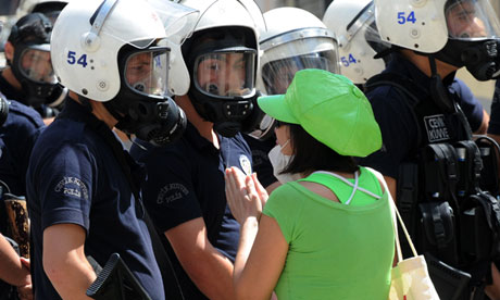 A woman confronts Turkish riot police during violent protests in Istanbul