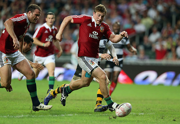 LIONS 2: Jonathan Davies of the Lions kicks the ball through for a try 