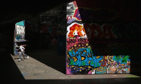 A skater runs with his board in the South Bank skate park, London, England.