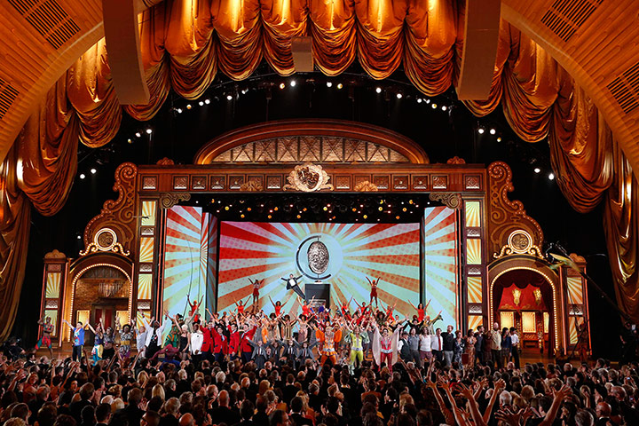 Tony awards: Host Neil Patrick Harris, hangs from a large replica of the Tony Award