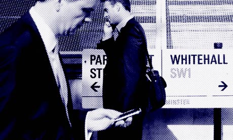 Pedestrians walk past a sign on Whitehall, in Westminster,