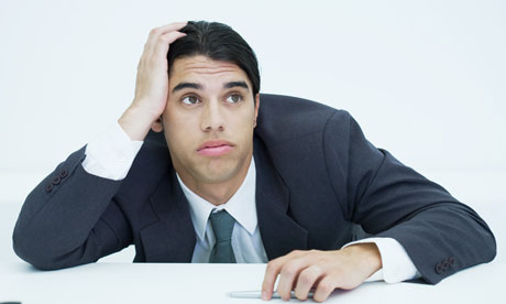 young businessman slouched on desk