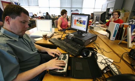 Jim Lewis operates a braille machine in the Sense office