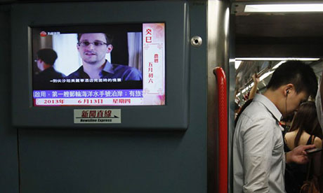 A news bulletin on a Hong Kong train shows Edward Snowden