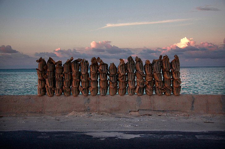 Kiribati, Pacific island: Newly made sandbags sit on a wall on a causeway that connects the town of B