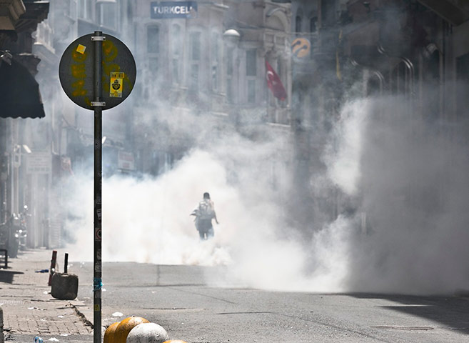 Turkey demonstrations: protestor in tear gas
