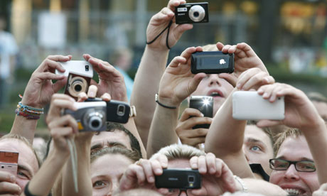 People using their cameras and mobile