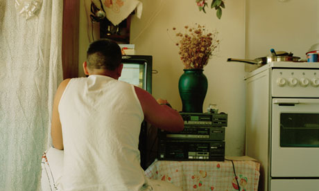 man sitting on floor using computer