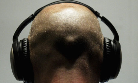 Man listens to iPod through headphones
