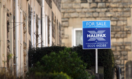 for sale sign outside row of houses