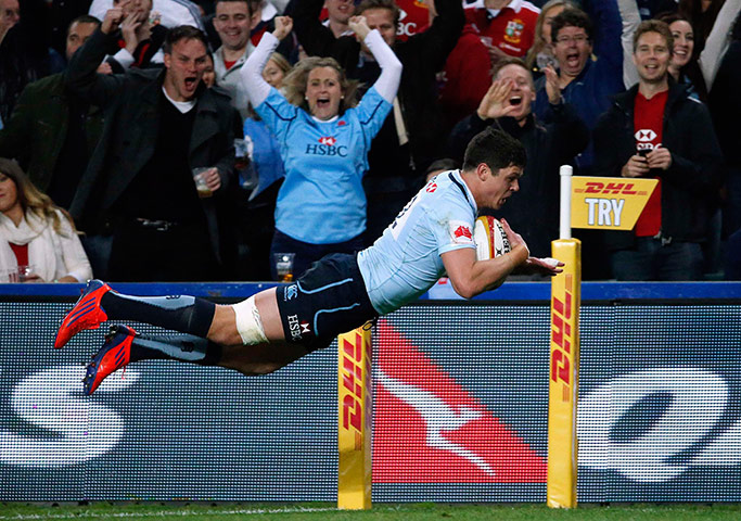 Lions Tour Match: Tom Carter from the New South Wales Waratahs dives over to score a try