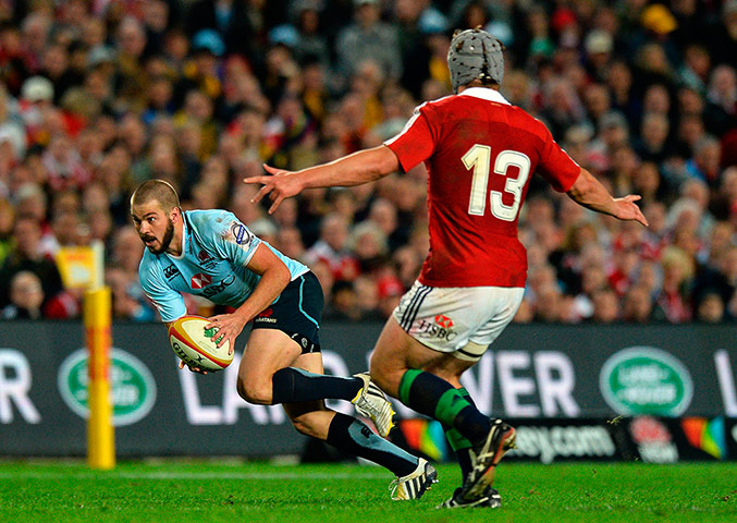 Lions Tour Match: Adam Jones of the Lions challenges Waratah 's Drew Mitchell