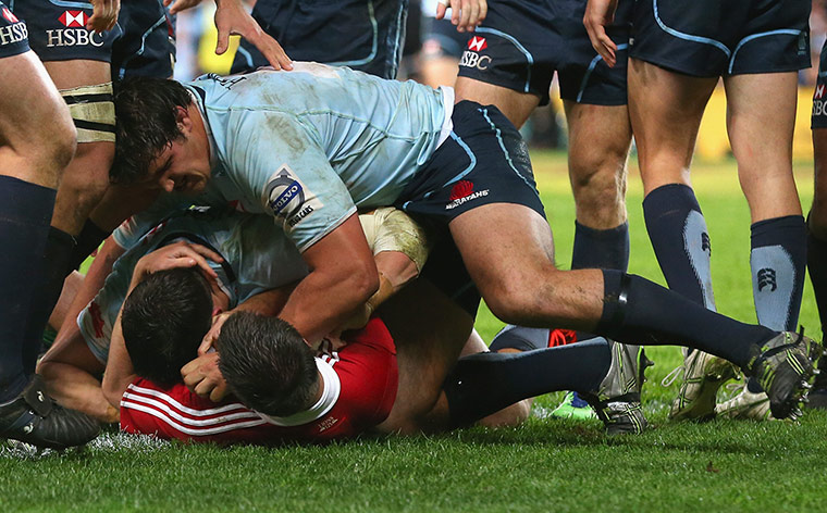 Lions Tour Match: Tom Carter and Jeremy Tilse of the Waratahs scuffle with Jonathan Sexton