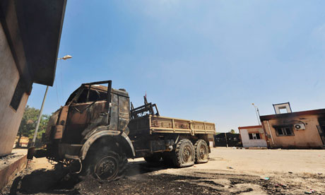 A burned truck is seen at the First Infantry Brigade base in Benghazi