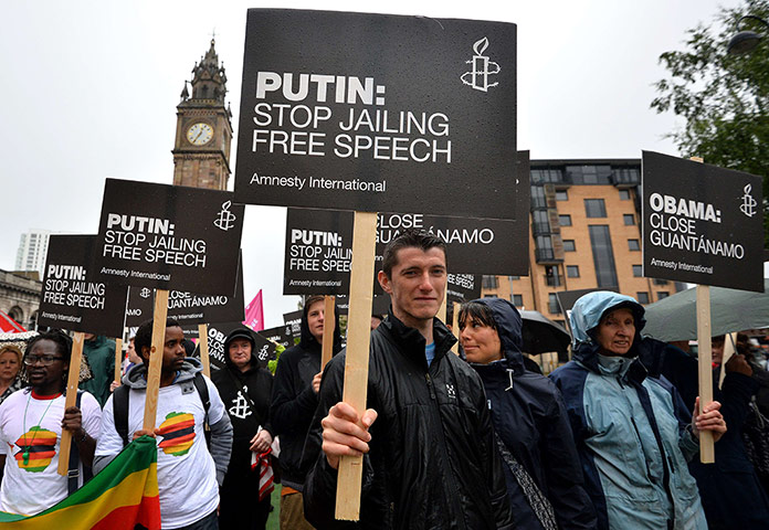 G8: Protesters carry placards directed at Vladimir Putin in Belfast