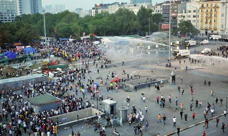 Riot police use a water cannon and tear