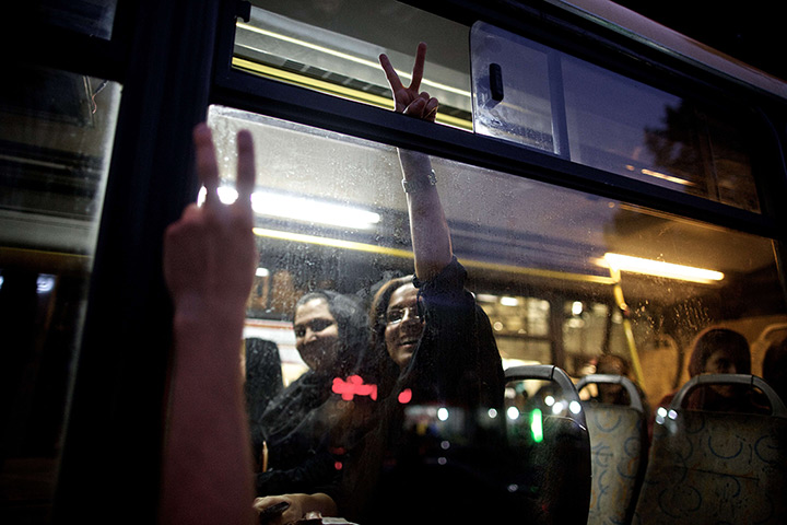 iran election celebration: A Rouhani supporter flashes the V-sign