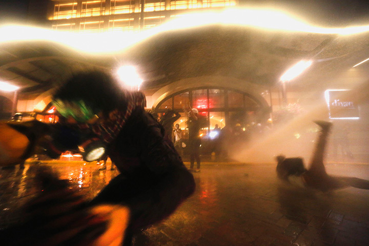the weekend in pictures: Protesters are attacked by police water cannon in Istanbul