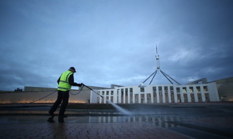 A Parliamentary worker hoses off the bird poo which has accumulated on the forecourt of Parliament House over the weekend. The Global Mail. Mike Bowers.