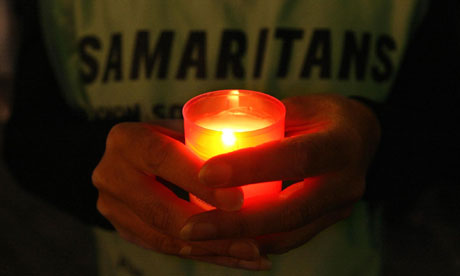Samaritans supporter holds a candle