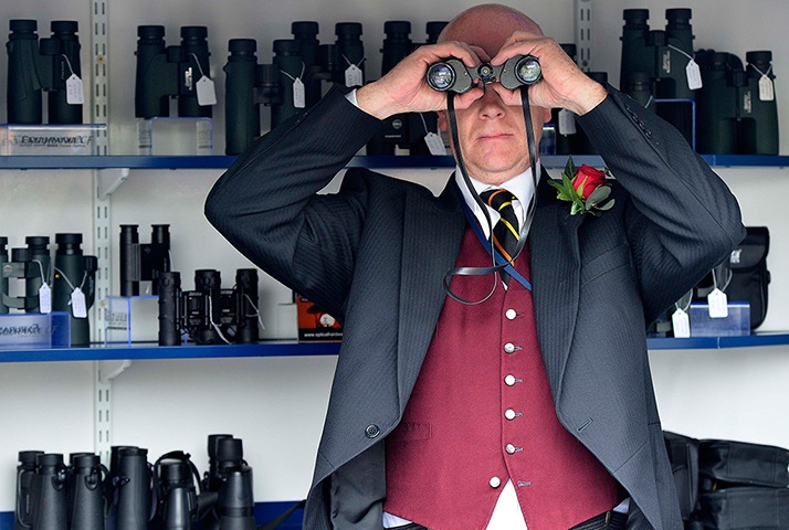 Ascot day one: A man checks his binoculars