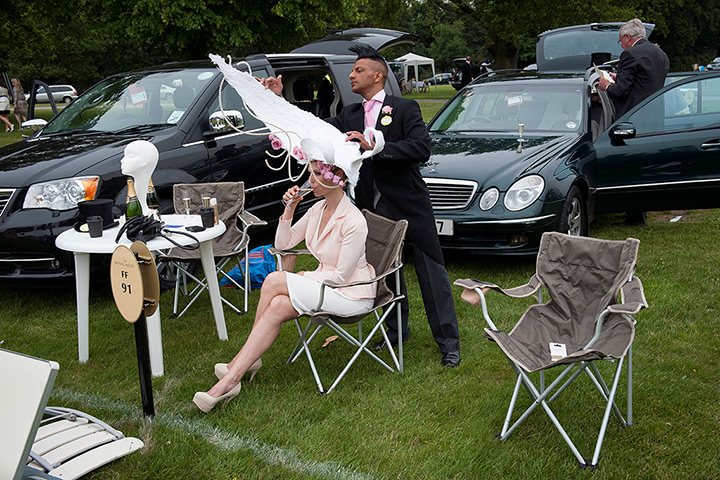 Ascot day one: Anneka Tanaka-Svenska has her extravagant hat adjusted by milliner Louis Ma