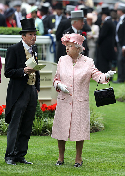 Ascot day one:: Queen Elizabeth II gestures her racing advisor John Warren