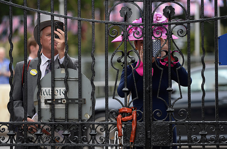 Tom Jenkins's Ascot Day 1: Racegoers take pictures through the gate 
