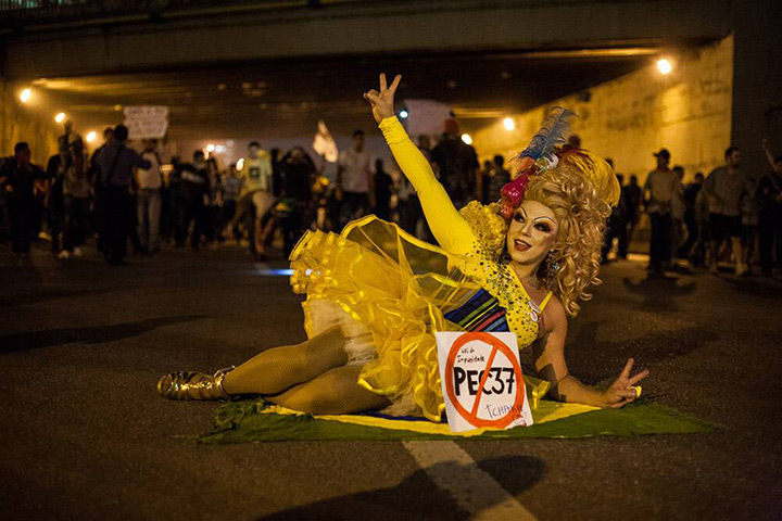 Brazil protests continue: A carnival dressed demonstrator gestures in Sao Paulo