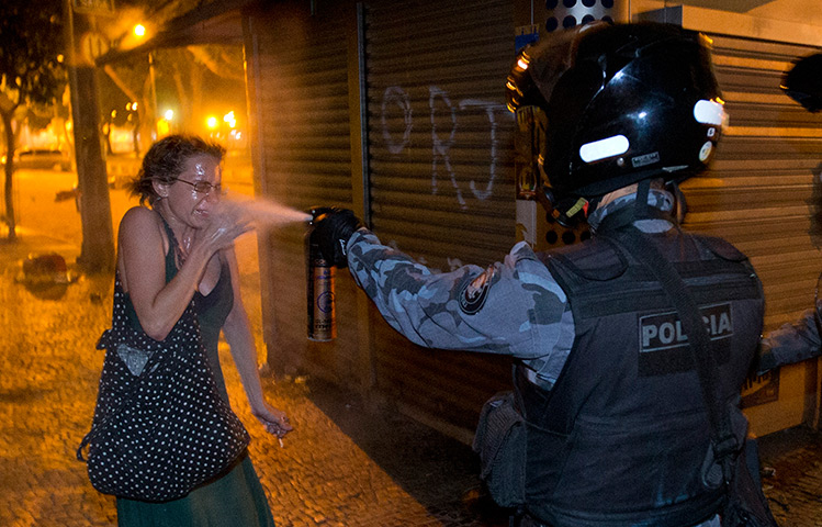 Brazil protests continue: Police pepper sprays a protester in Rio de Janeiro