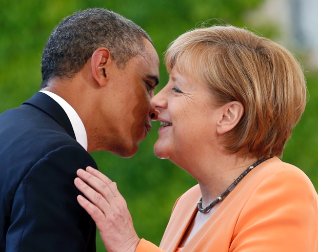 One kiss or two wonders Barack Obama as he is welcomed by German Chancellor Angela Merkel at the chancellery in Berlin, Germany.
