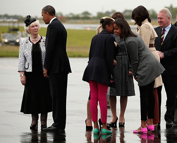 Malia and Sasha Obama: Sasha and Malia Obama whisper as Barack Obama  is greeted upon their arriva