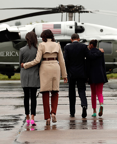 Malia and Sasha Obama: Barack Obama and Michelle Obama embrace their daughters as the walk to Mari