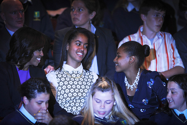 Malia and Sasha Obama: Michelle Obama and her two daughters laugh as they await the start of the R
